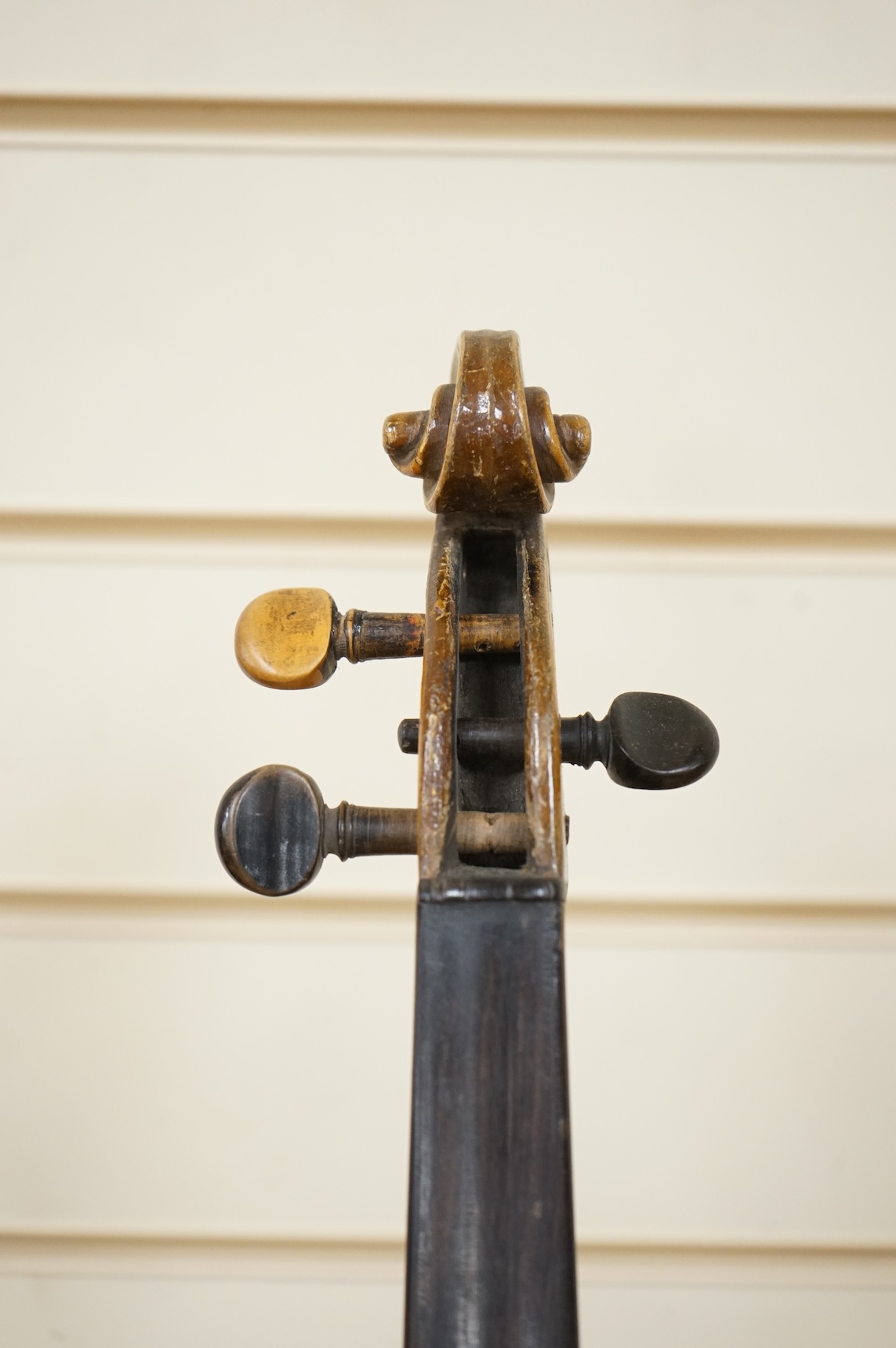 Four violins; a German Dresden violin, together with further two German violins, and a Saxony violin, three in cases or the remains of cases.